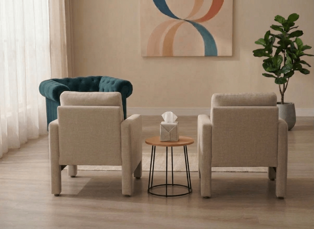 A middle-aged female counselor speaking to a couple seated across from her in a therapy session
